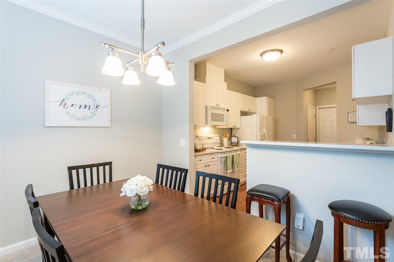3151 Hemlock Forest Circle, Unit 102 Raleigh, NC 27612 - Photo 15 of 26 a view of a dining room with furniture