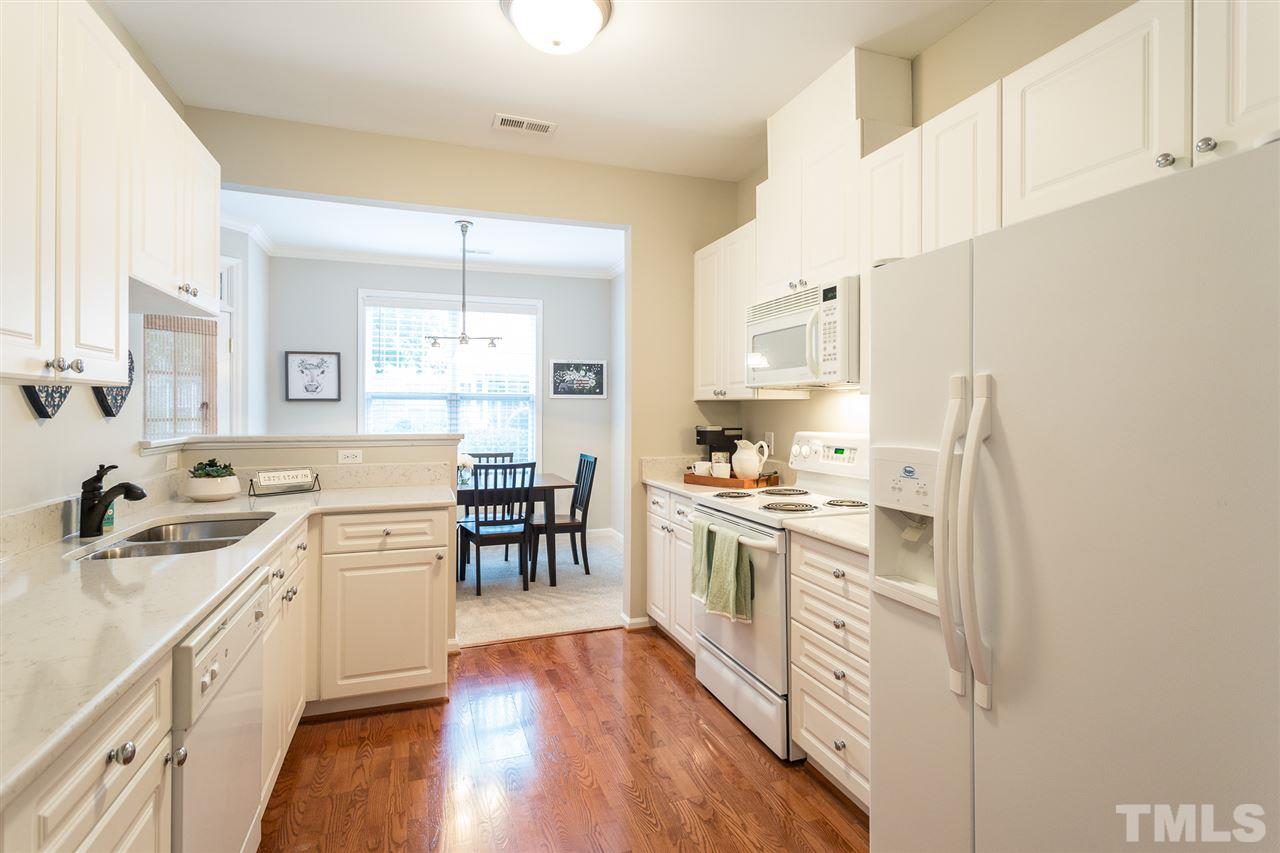3151 Hemlock Forest Circle, Unit 102 Raleigh, NC 27612 - Photo 16 of 26 a kitchen with a sink stove and cabinets