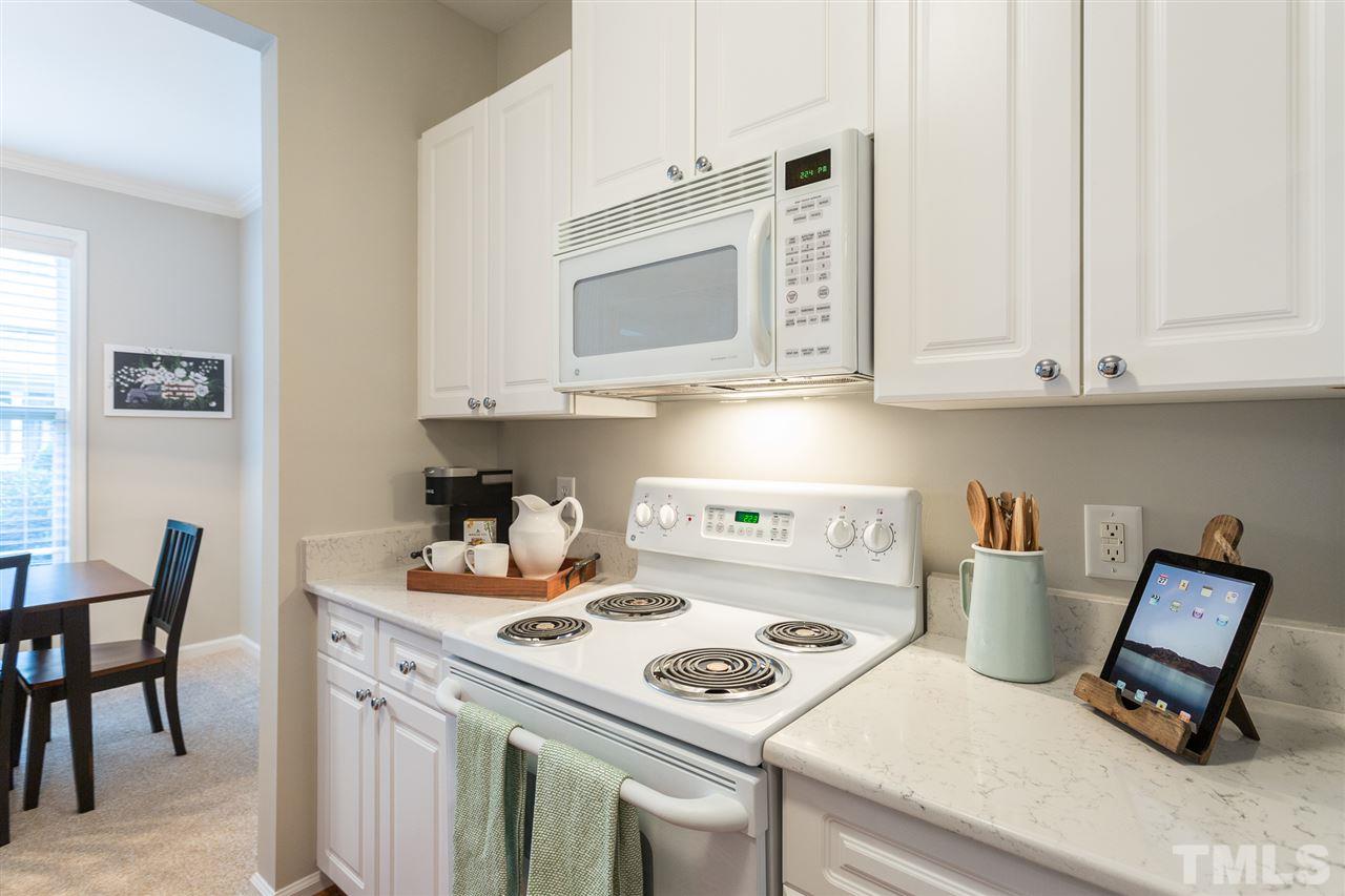 3151 Hemlock Forest Circle, Unit 102 Raleigh, NC 27612 - Photo 19 of 26 a kitchen with a stove and a microwave