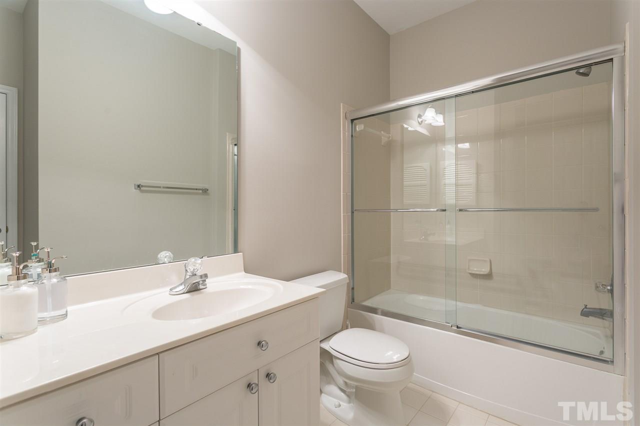 3151 Hemlock Forest Circle, Unit 102 Raleigh, NC 27612 - Photo 26 of 26 a bathroom with a sink and a mirror