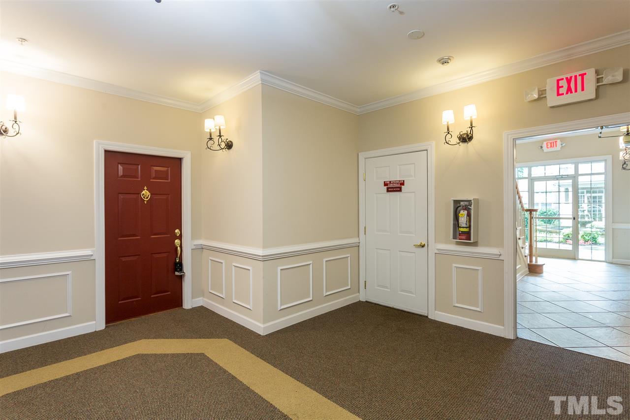 3151 Hemlock Forest Circle, Unit 102 Raleigh, NC 27612 - Photo 7 of 26 a view of a hallway with an empty room