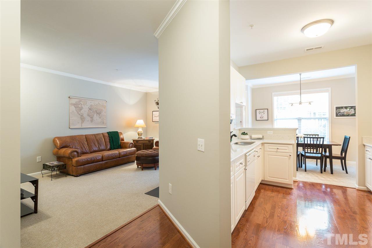 3151 Hemlock Forest Circle, Unit 102 Raleigh, NC 27612 - Photo 8 of 26 a living room with furniture and a wooden floor