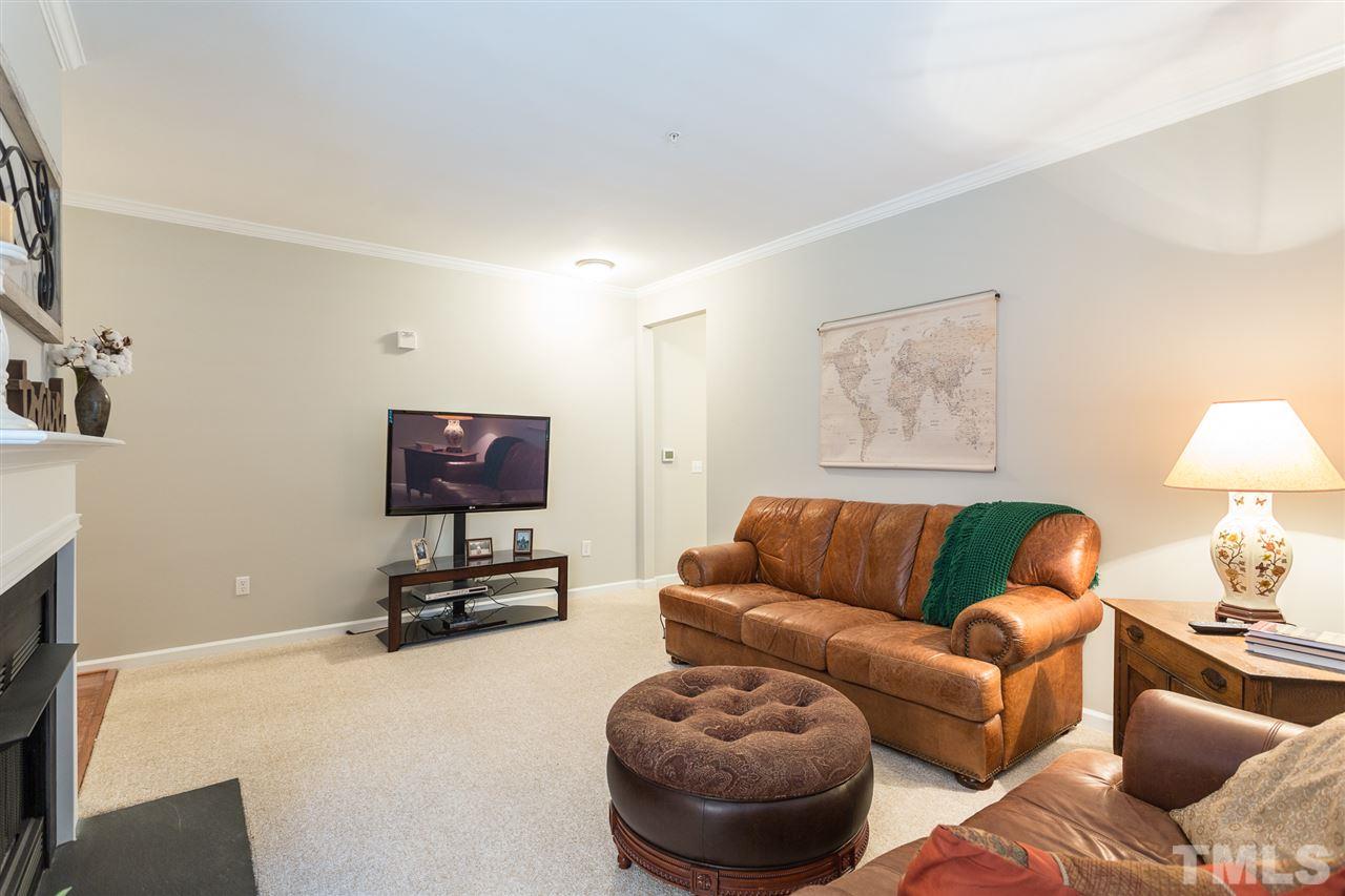 3151 Hemlock Forest Circle, Unit 102 Raleigh, NC 27612 - Photo 10 of 26 a living room with furniture a couch and a flat screen tv
