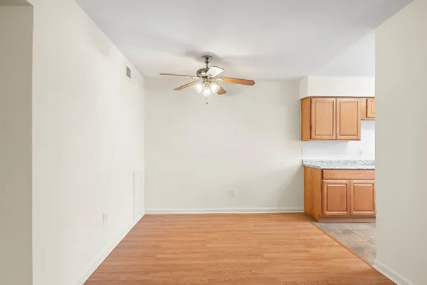 a view of a kitchen with granite countertop cabinets and wooden floor