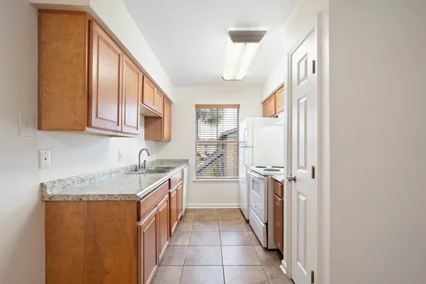 a kitchen with a sink stove and refrigerator