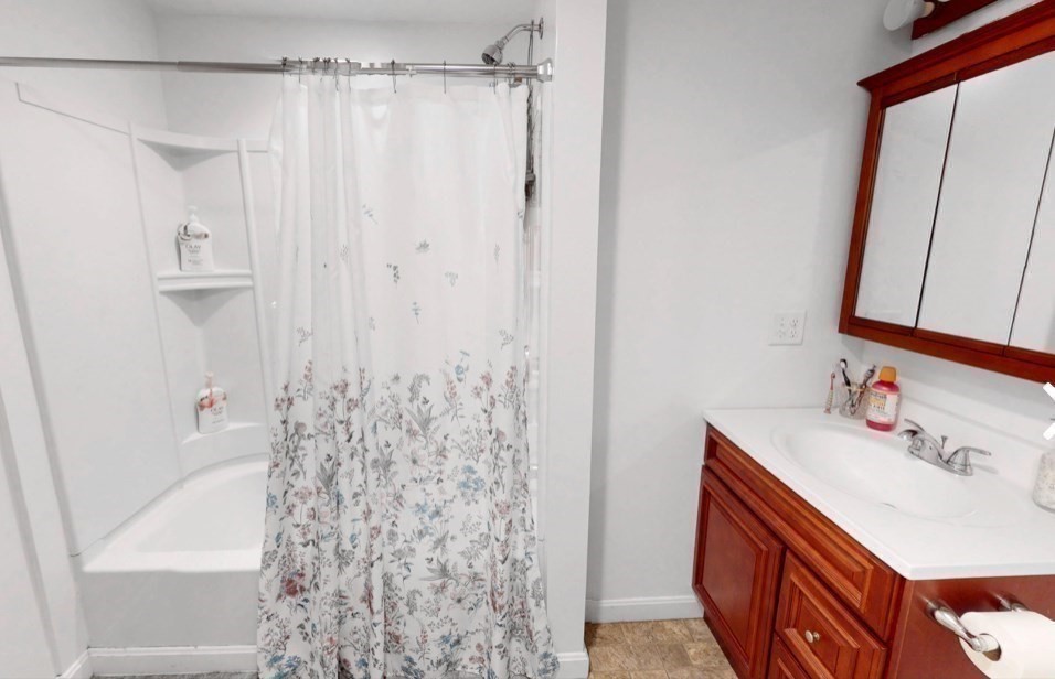 5 B Swan Avenue Worcester, MA 01602 - Photo 5 of 18 a bathroom with a sink a mirror and a shower curtain
