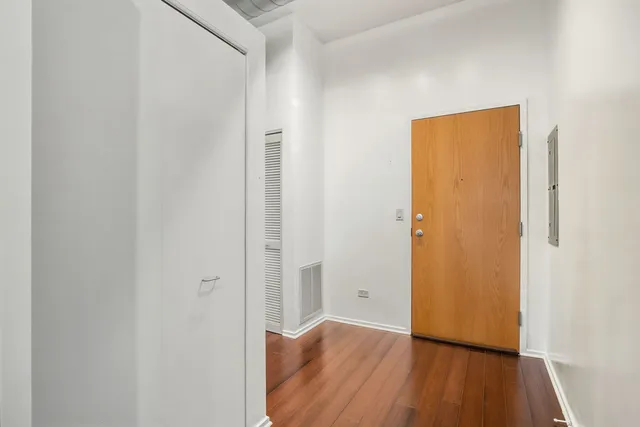 a view of a hallway with wooden floor