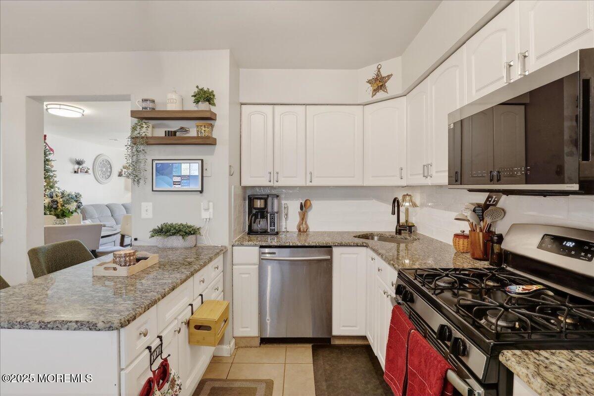 73 Rita Lane Jackson, NJ 08527 - Photo 12 of 32 a kitchen with granite countertop a sink stove and refrigerator