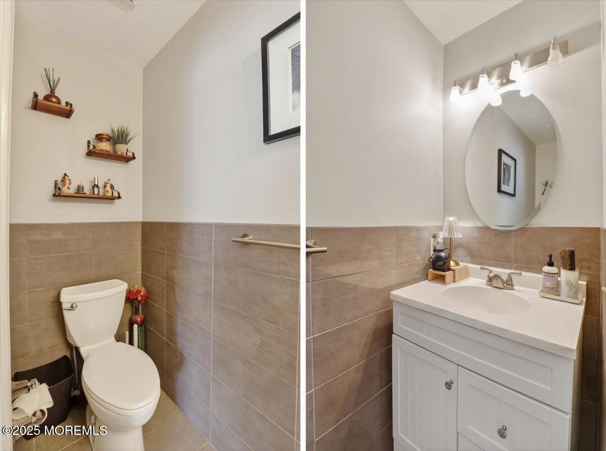 73 Rita Lane Jackson, NJ 08527 - Photo 14 of 32 a bathroom with a toilet sink vanity and mirror
