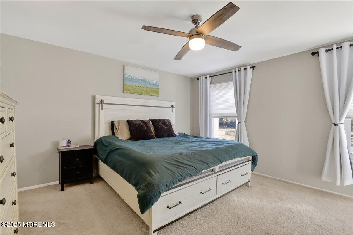 73 Rita Lane Jackson, NJ 08527 - Photo 17 of 32 a bed sitting in a bedroom next to a window