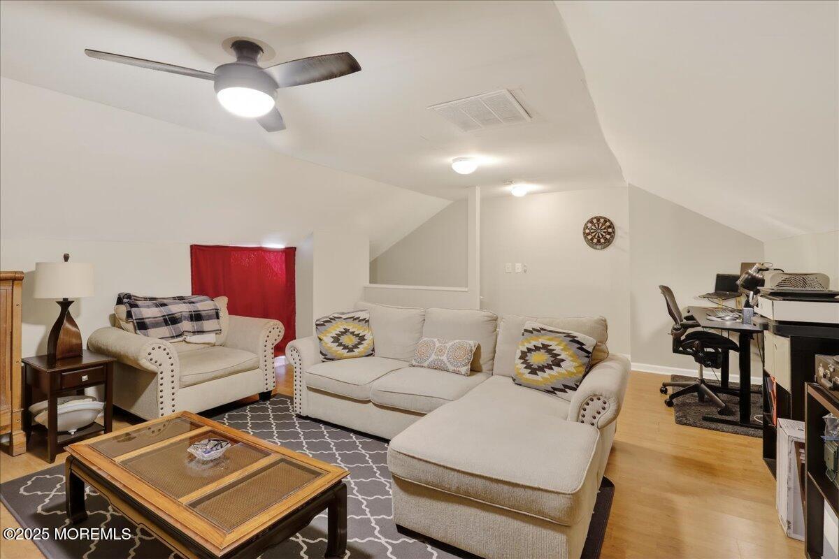 73 Rita Lane Jackson, NJ 08527 - Photo 23 of 32 a living room with furniture and a chandelier