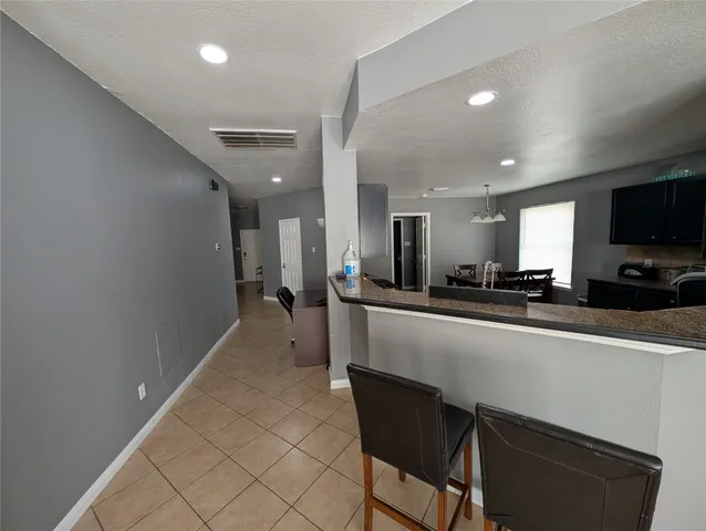 a dining hall with stainless steel appliances a refrigerator and a sink