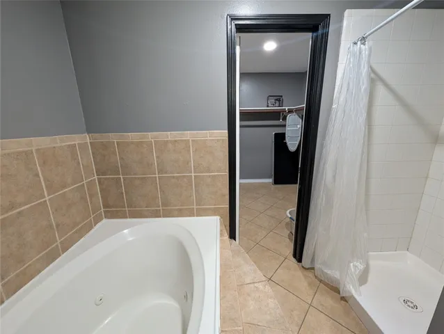 a bathroom with a bathtub and a shower