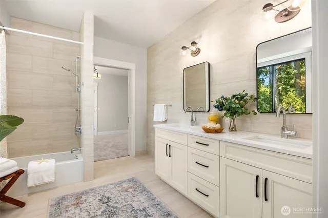 a bathroom with a granite countertop sink a toilet a mirror and shower