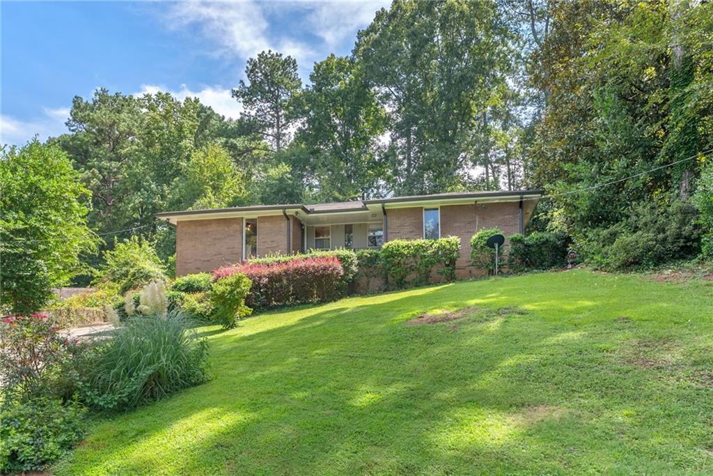 1449 Southland Vista Court Northeast, Unit B Atlanta, GA 30329 - Photo 18 of 26 a view of a house with a yard and potted plants