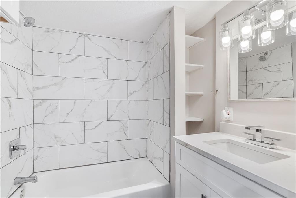 1449 Southland Vista Court Northeast, Unit B Atlanta, GA 30329 - Photo 9 of 26 a bathroom with a sink and shower