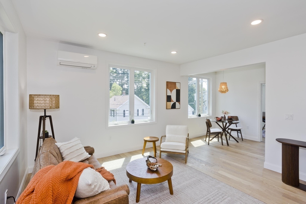 107 Williams Street, Unit 3C Northampton, MA 01060 - Photo 11 of 19 a living room with furniture and a wooden floor