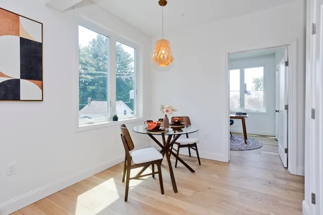 a view of a dining room with furniture window and wooden floor
