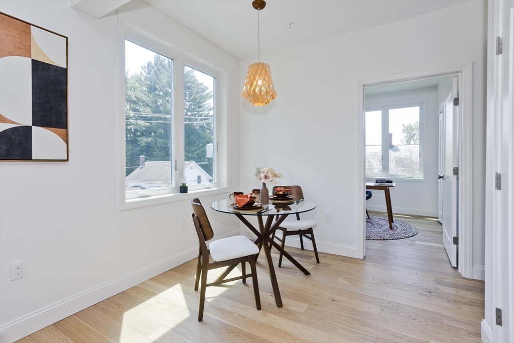 107 Williams Street, Unit 3C Northampton, MA 01060 - Photo 13 of 19 a view of a dining room with furniture window and wooden floor