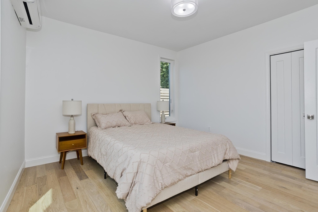 107 Williams Street, Unit 3C Northampton, MA 01060 - Photo 18 of 19 a bedroom with a bed and wooden floor