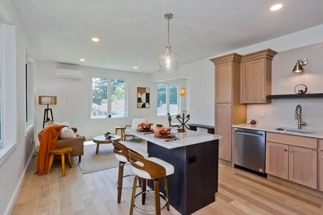 a kitchen with stainless steel appliances granite countertop a sink a stove and a refrigerator