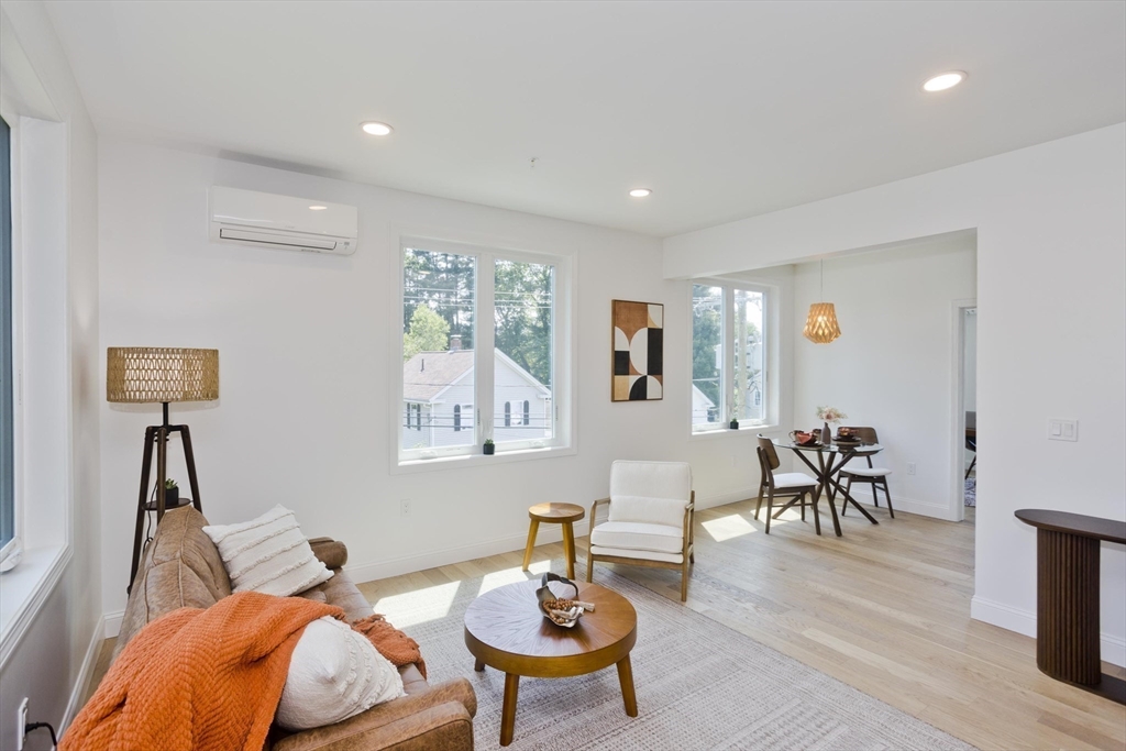 107 Williams Street, Unit 3C Northampton, MA 01060 - Photo 10 of 19 a living room with furniture and a wooden floor
