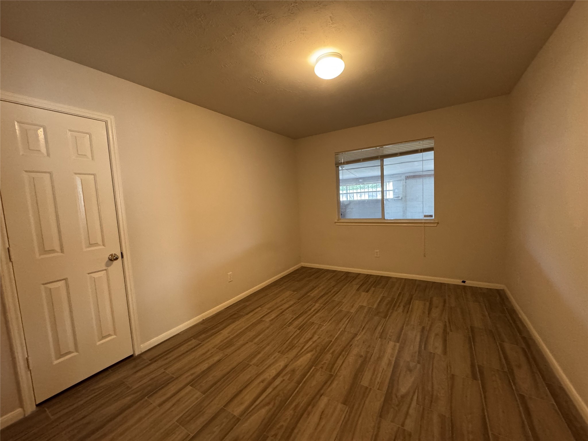 13723 Audra Lane Houston, TX 77083 - Photo 15 of 18 an empty room with wooden floor and windows
