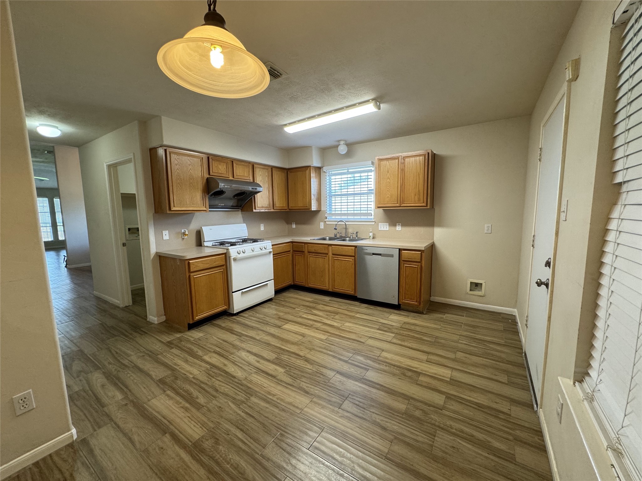 13723 Audra Lane Houston, TX 77083 - Photo 8 of 18 a kitchen with stainless steel appliances a stove top oven a sink dishwasher and a refrigerator