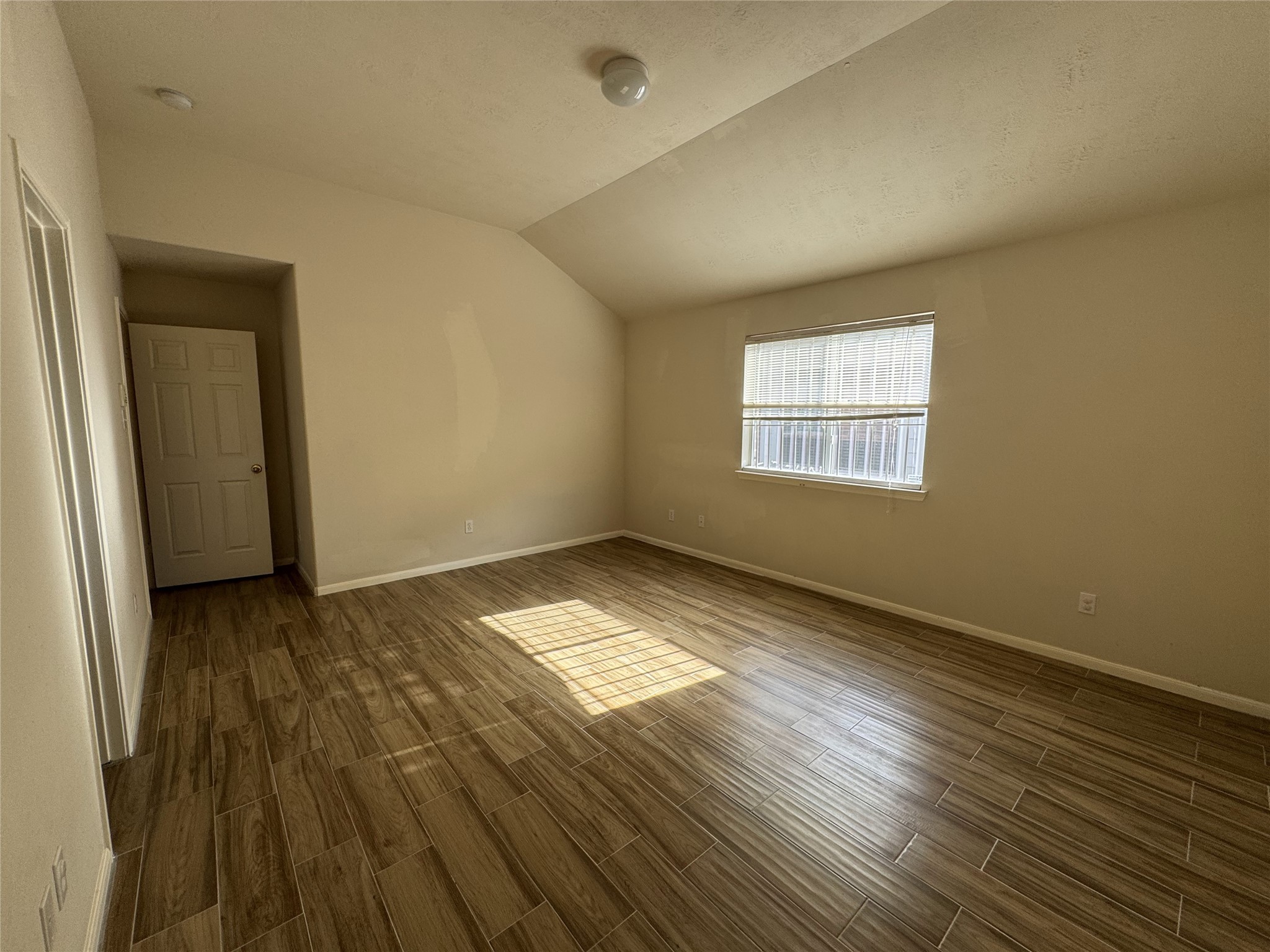 13723 Audra Lane Houston, TX 77083 - Photo 10 of 18 an empty room with wooden floor and windows