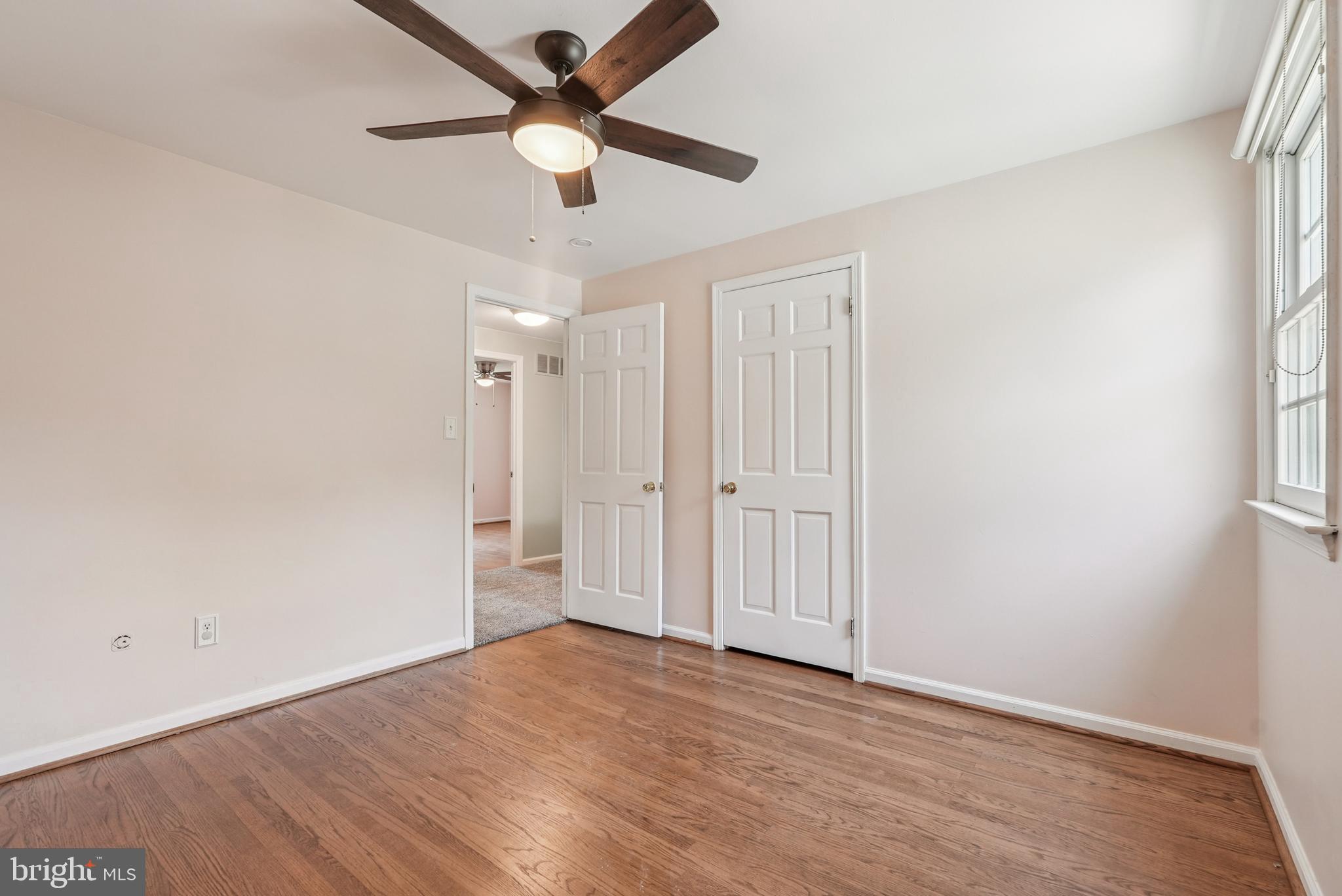 10 Rooftree Road Cherry Hill, NJ 08003 - Photo 42 of 58 an empty room with wooden floor ceiling fan and windows