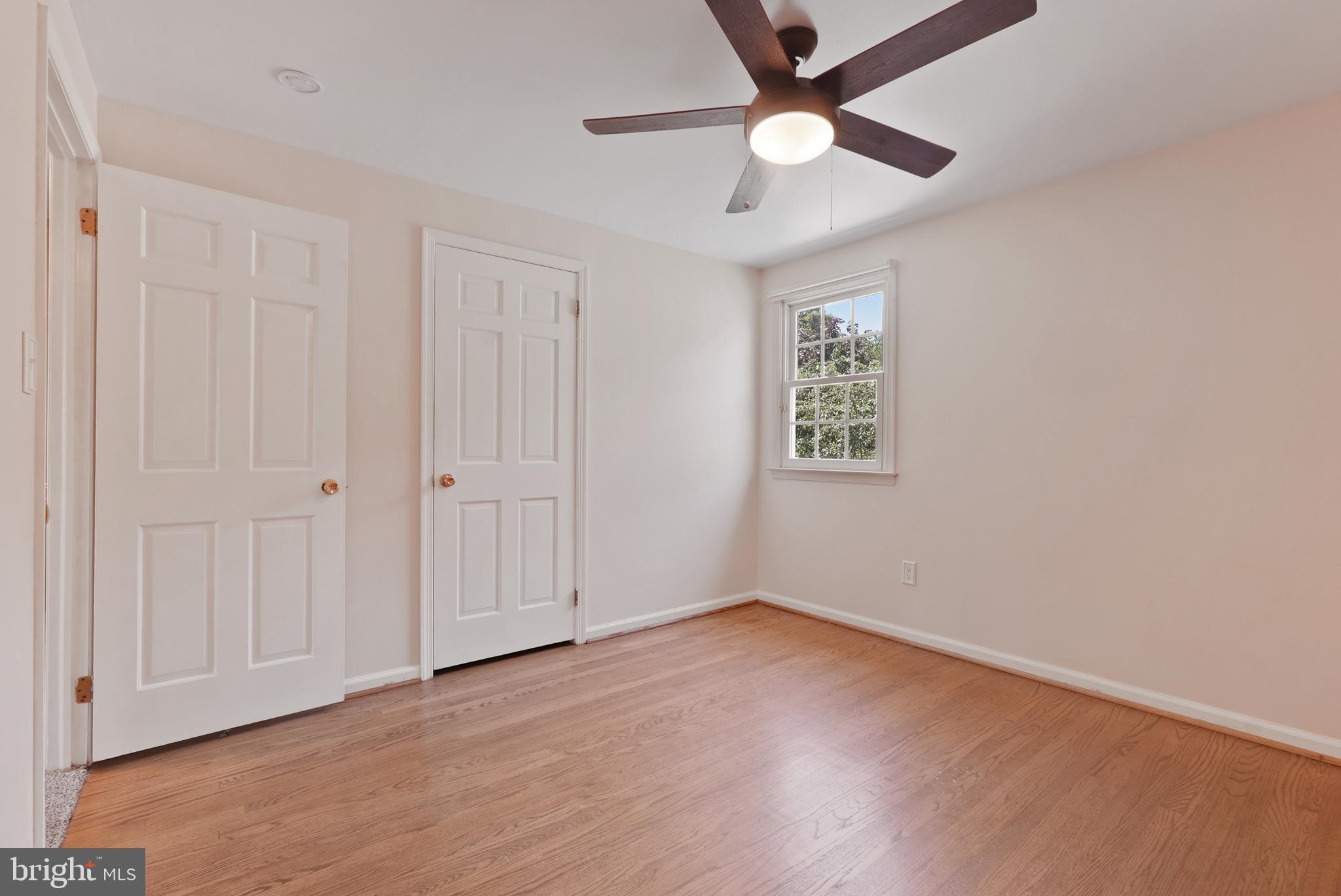 10 Rooftree Road Cherry Hill, NJ 08003 - Photo 44 of 58 an empty room with wooden floor ceiling fan and windows