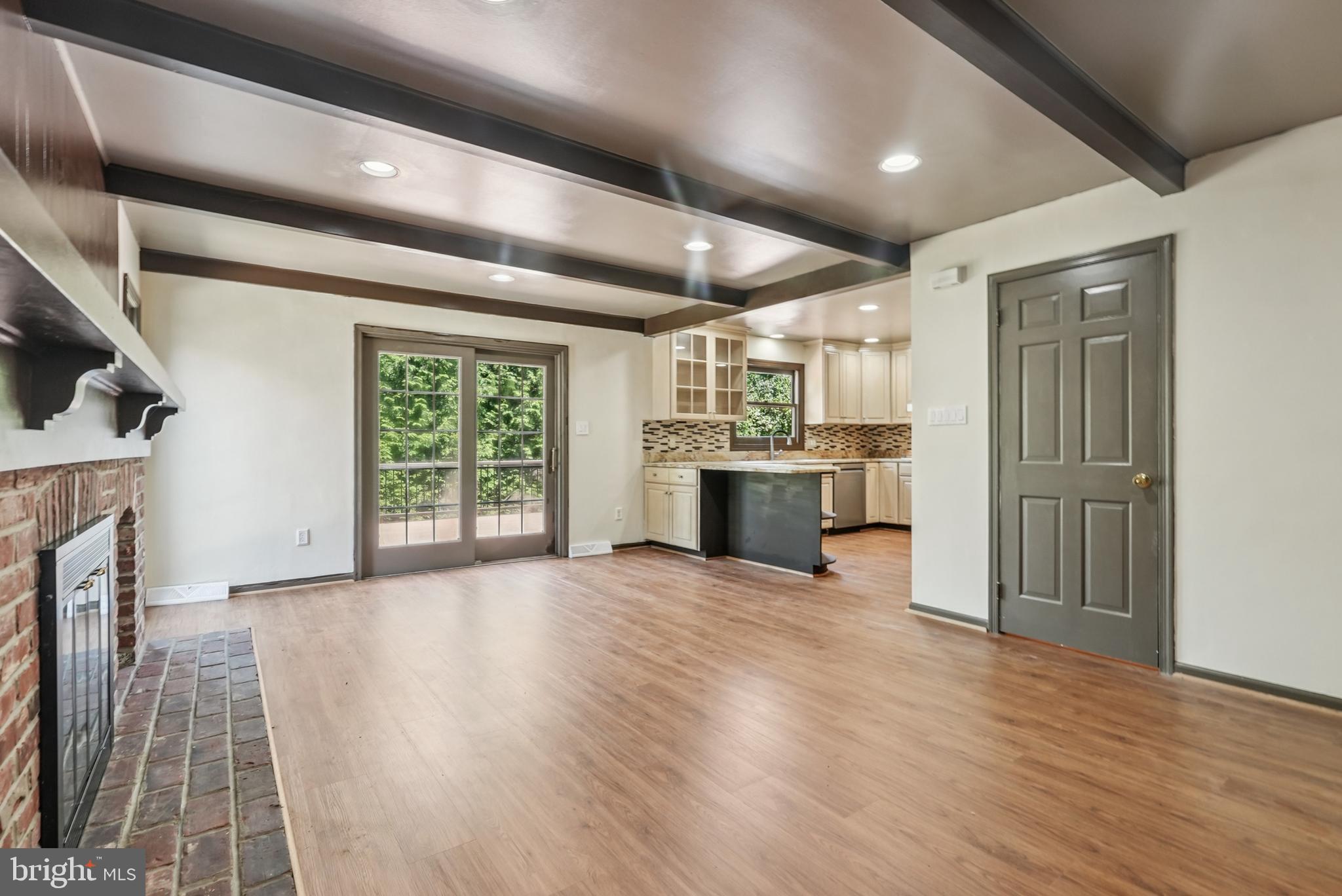 10 Rooftree Road Cherry Hill, NJ 08003 - Photo 8 of 58 an empty room with wooden floor fireplace and windows