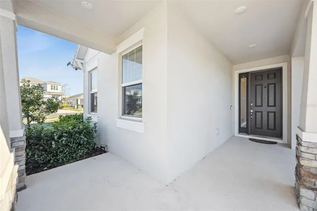 a kitchen with stainless steel appliances granite countertop a refrigerator a sink a stove and white cabinets