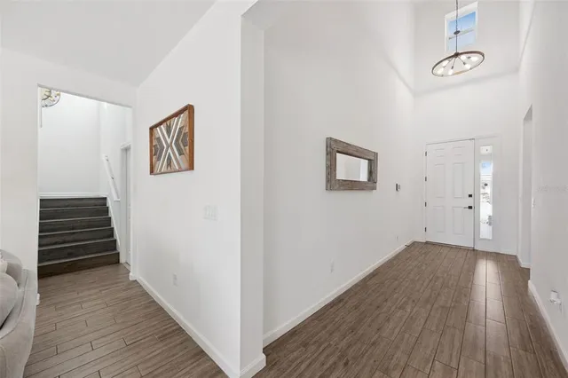 a kitchen with stainless steel appliances kitchen island granite countertop a table chairs and white cabinets