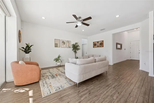 a kitchen with stainless steel appliances sink stove refrigerator and wooden floor