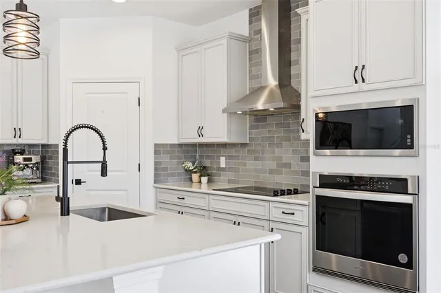 a living room with furniture and a hard wood floor