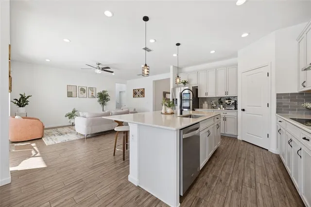 a living room with furniture and a wooden floor