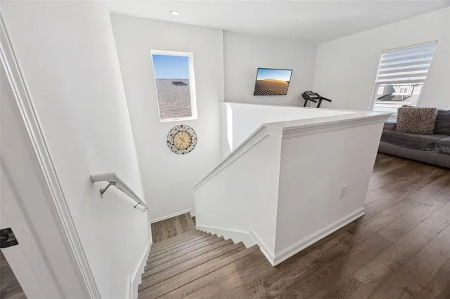 a bedroom with furniture and a wooden floor