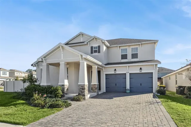 a living room with furniture kitchen view and a potted plant