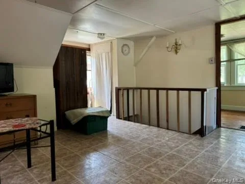 a living room with furniture a window and a flat screen tv