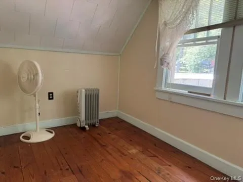 an empty room with wooden floor and closet