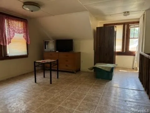 a bedroom with bed and a window