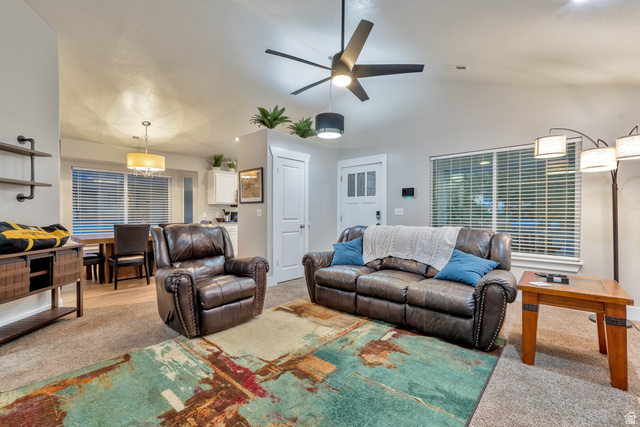 Undisclosed Address Ogden, UT 84403 - Photo 14 of 21 Living room featuring ceiling fan, light colored carpet, and lofted ceiling