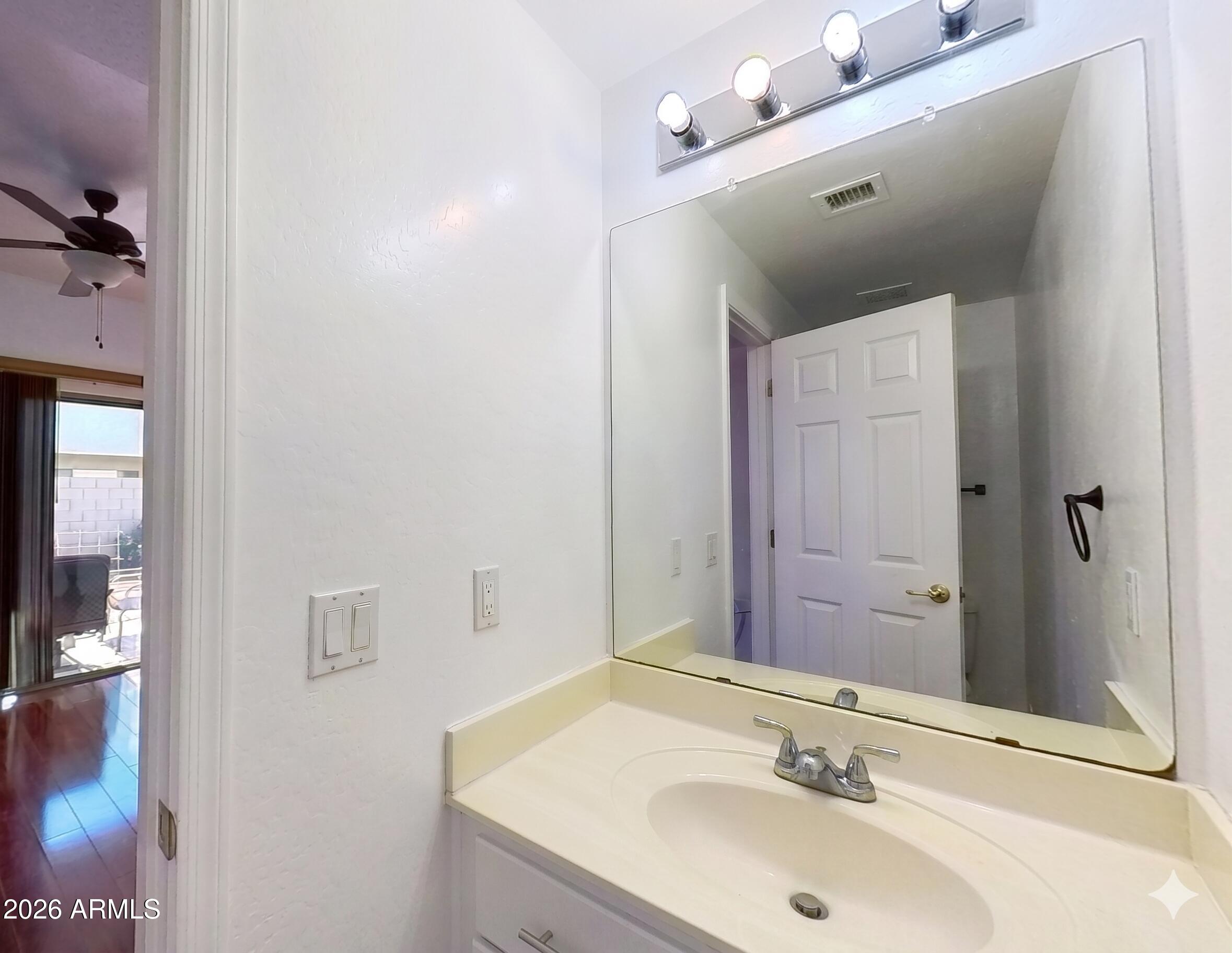 7206 South 12th Way Phoenix, AZ 85042 - Photo 13 of 34 a bathroom with a sink and mirror