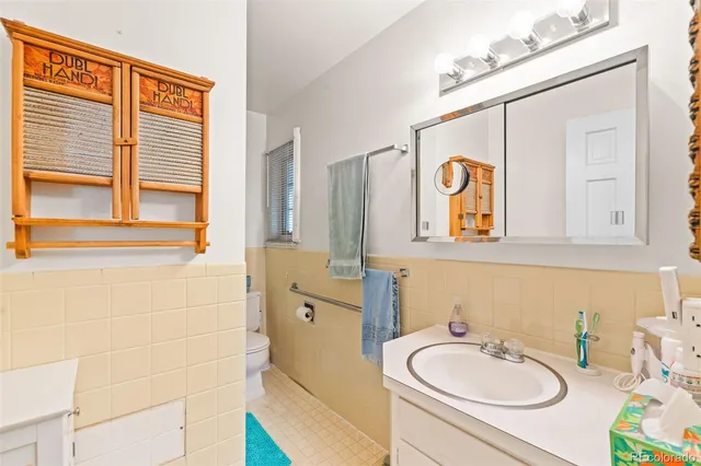 a bathroom with a sink a mirror and a window