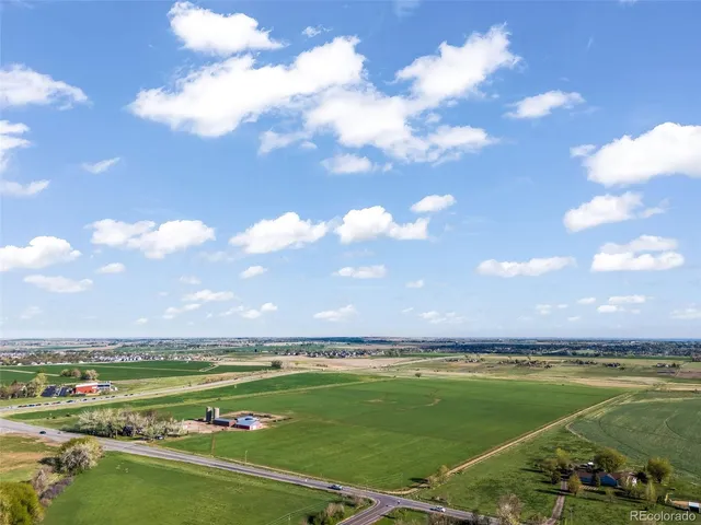 a view of a city and swimming pool with outdoor seating