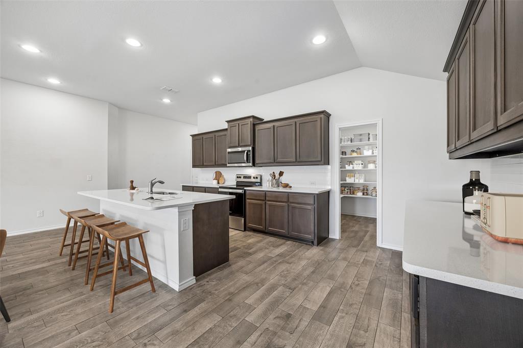 3807 Dogwood Road Melissa, TX 75454 - Photo 7 of 38 a kitchen with a sink a counter top space stainless steel appliances and cabinets