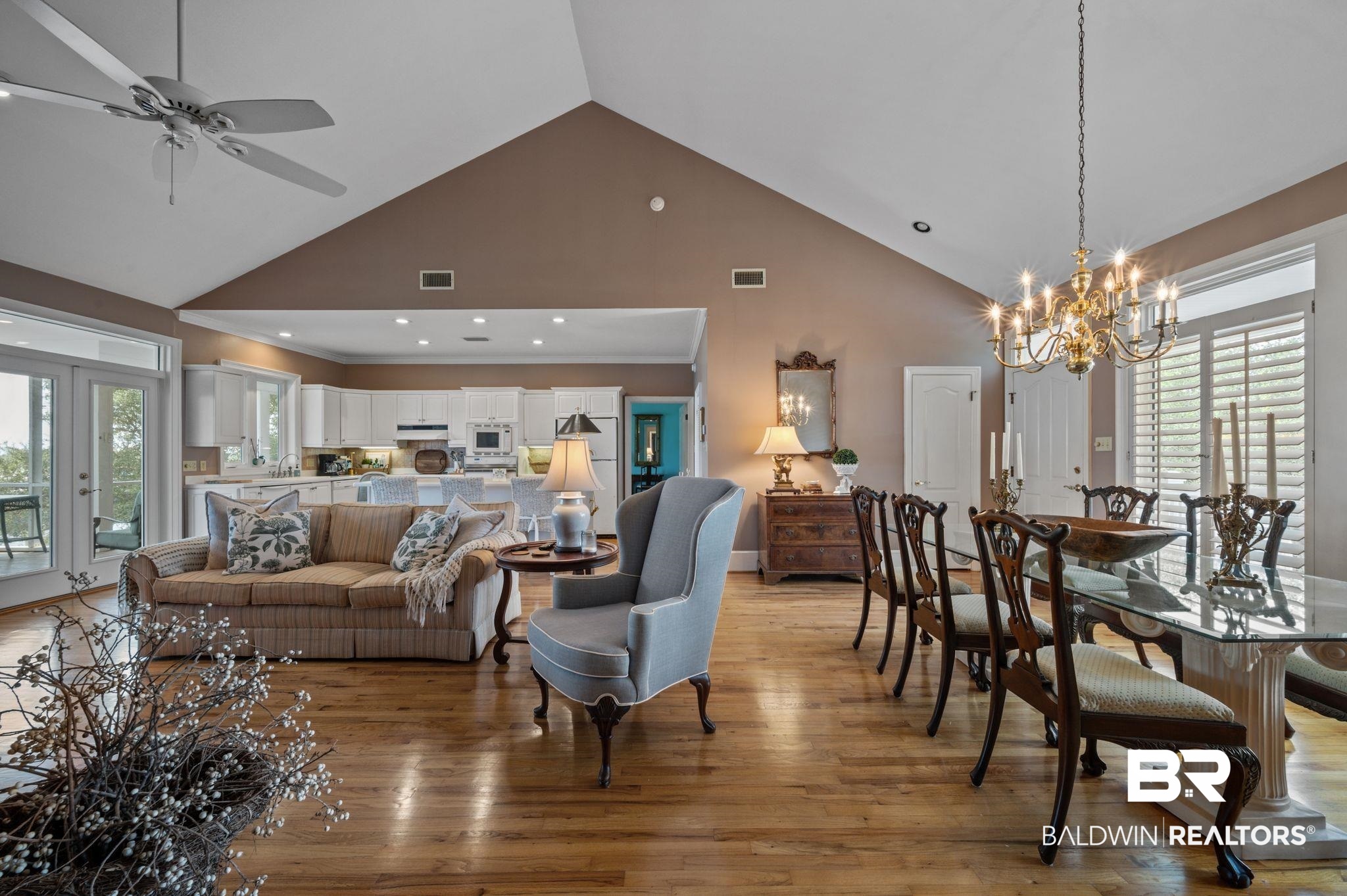 31800 River Road Orange Beach, AL 36561 - Photo 12 of 69 Living room with high vaulted ceiling, light hardwood / wood-style floors, and ceiling fan with notable chandelier