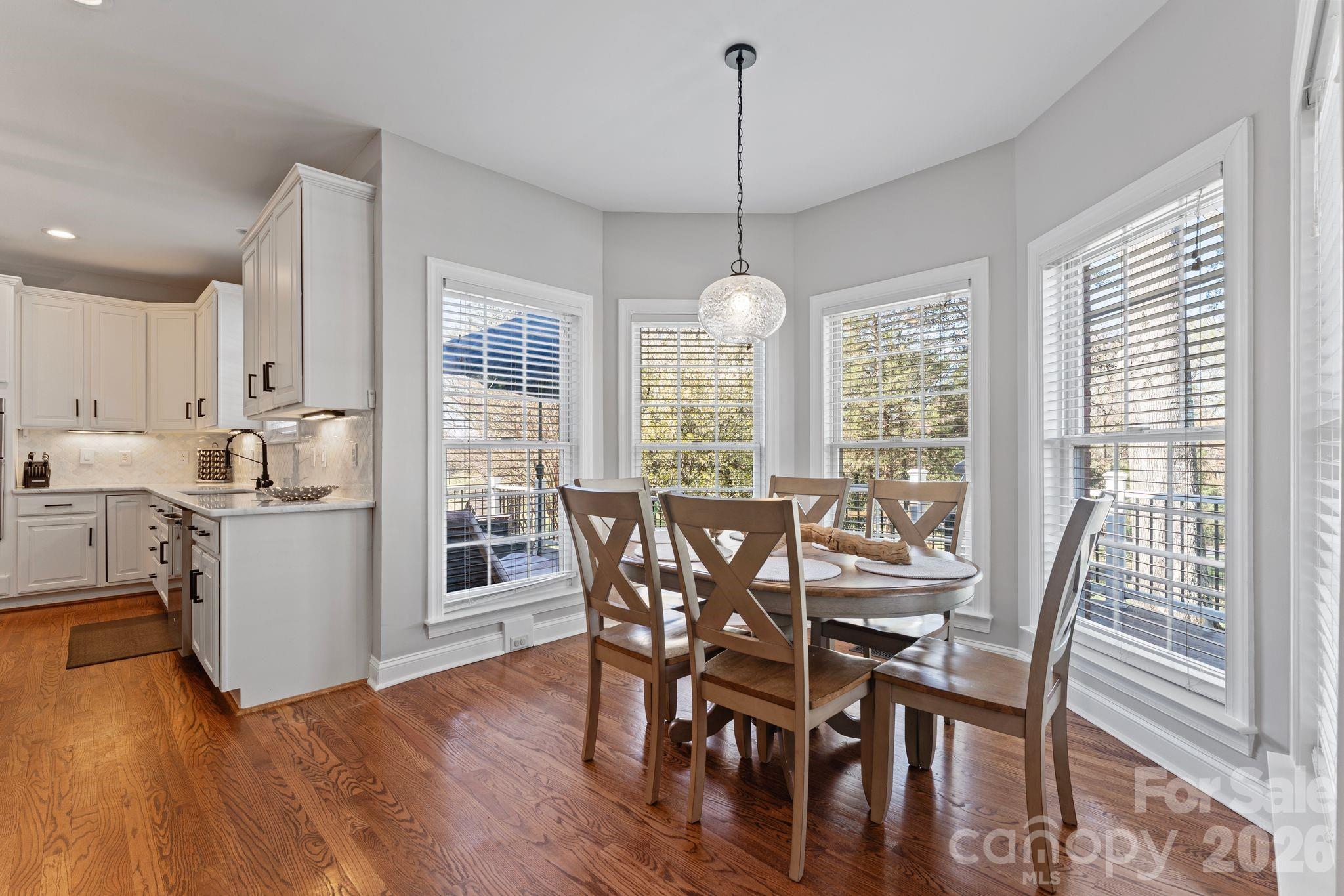 9618 Cockerham Lane Huntersville, NC 28078 - Photo 11 of 37 a view of a dining room with furniture window and wooden floor