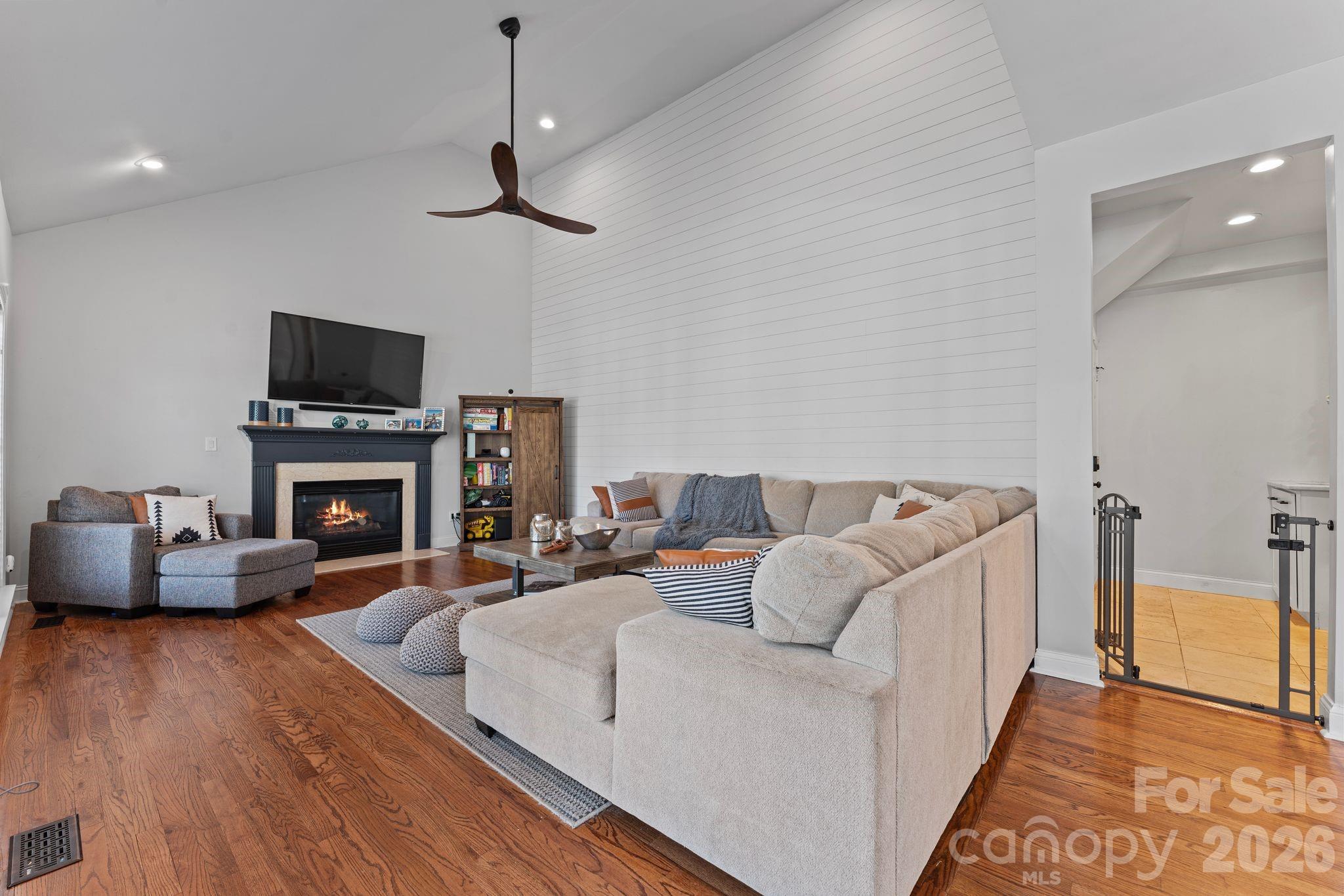 9618 Cockerham Lane Huntersville, NC 28078 - Photo 12 of 37 a living room with furniture a fireplace and a flat screen tv